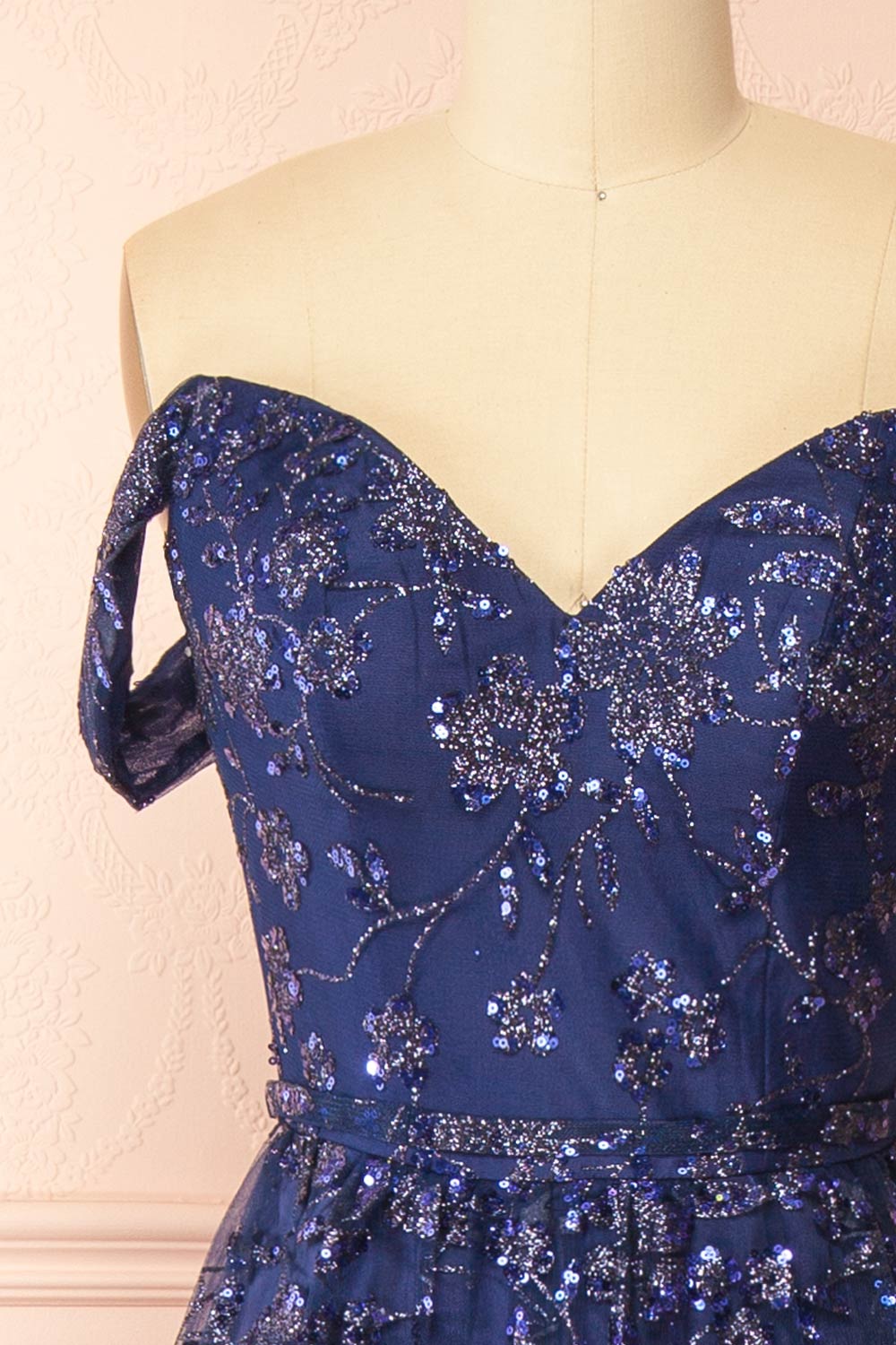 front of sewing mannequin wearing Alienor navy Glittery Off the Shoulder Maxi Dress from Boutique 1861