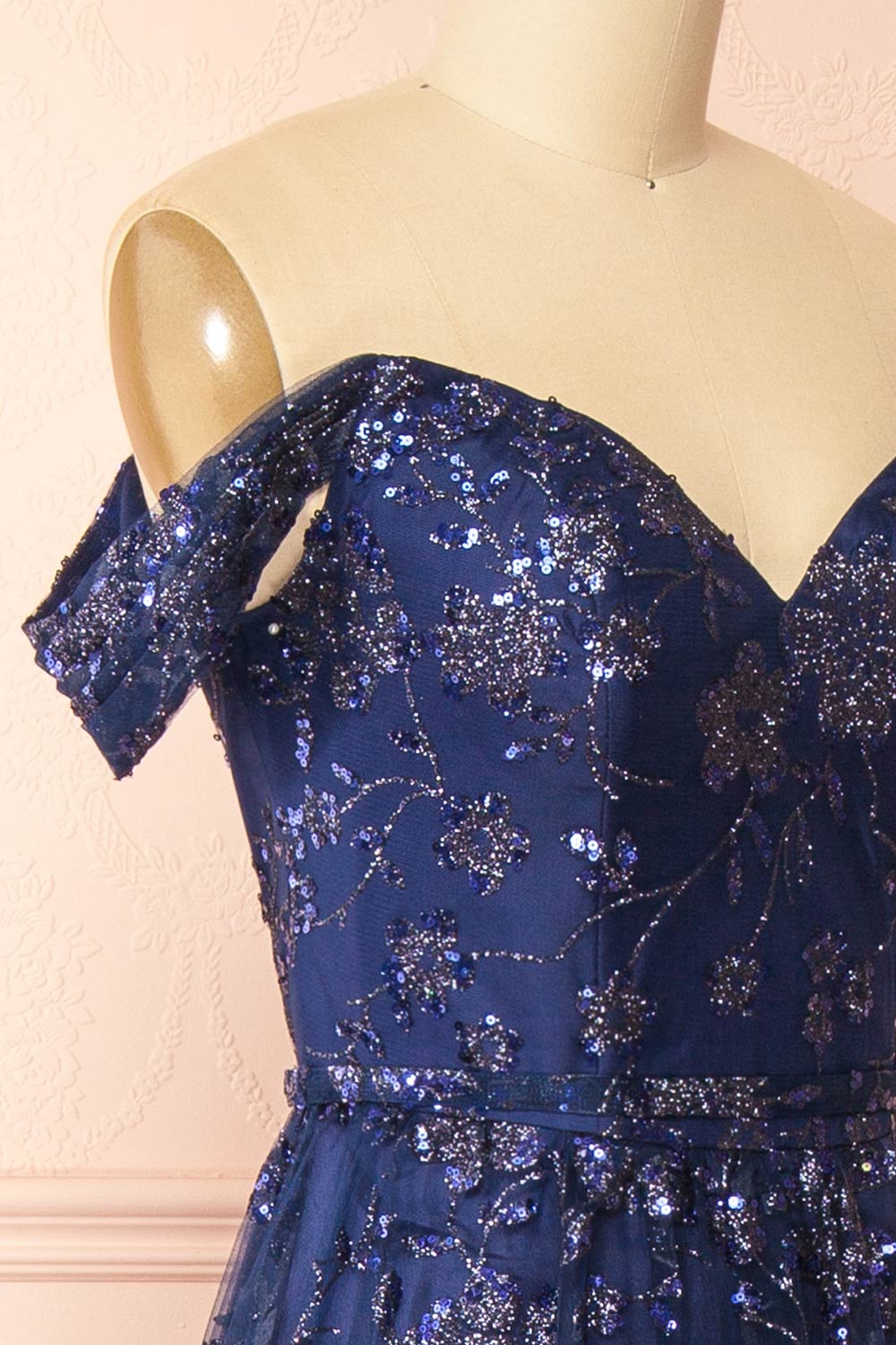 side of sewing mannequin wearing Alienor navy Glittery Off the Shoulder Maxi Dress from Boutique 1861