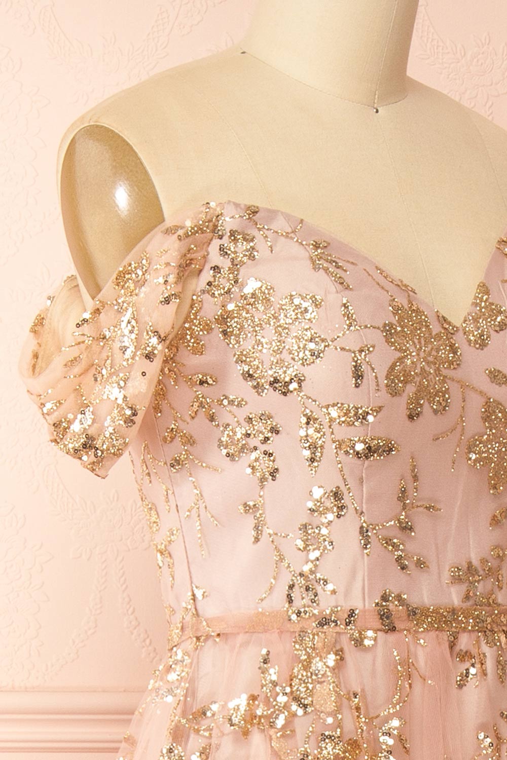 side of sewing mannequin wearing Alienor Taupe Glittery Off the Shoulder Maxi Dress from Boutique 1861