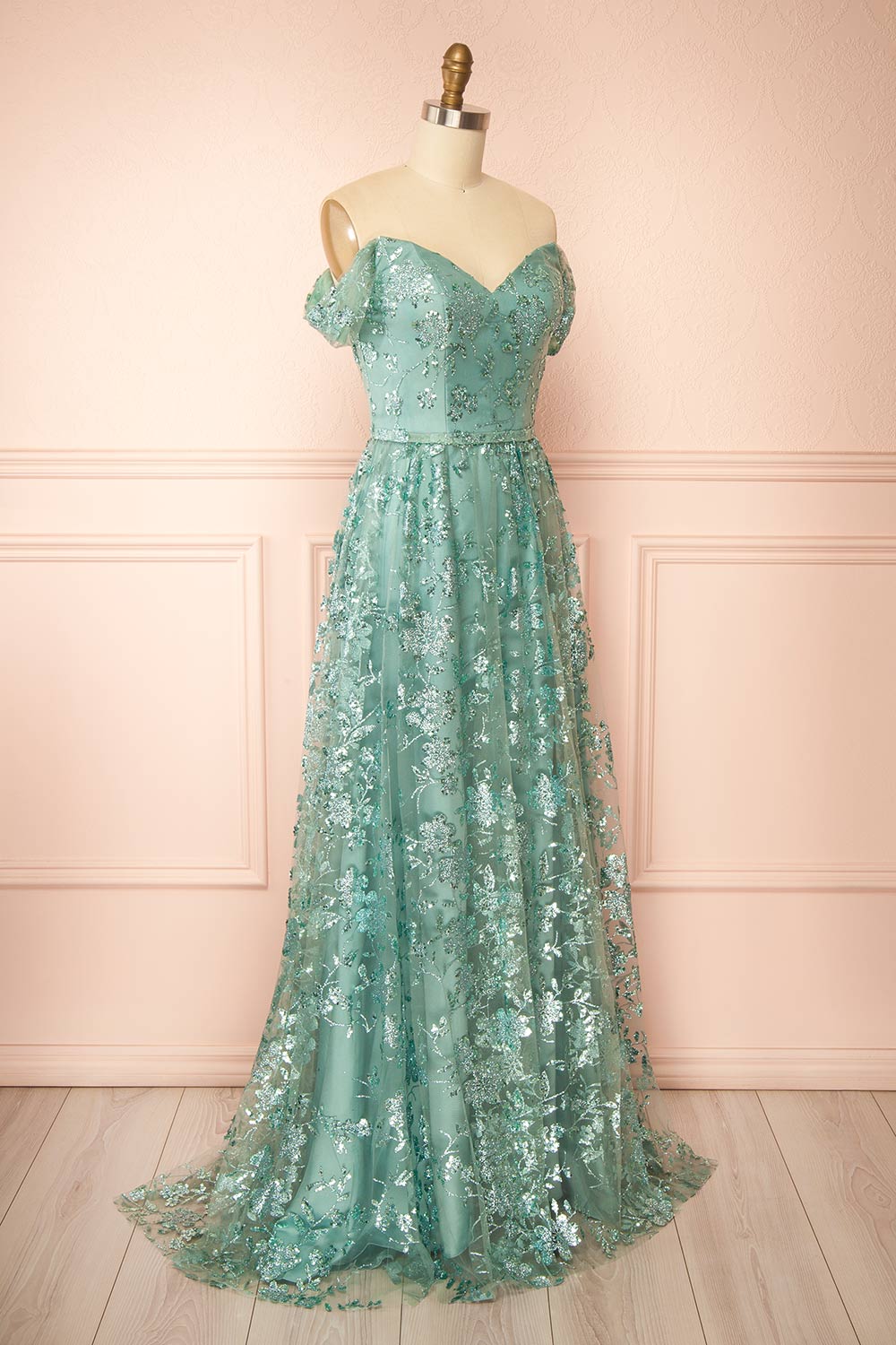 side view of sewing mannequin wearing Alienor Teal Glittery Off the Shoulder Maxi Dress from Boutique 1861
