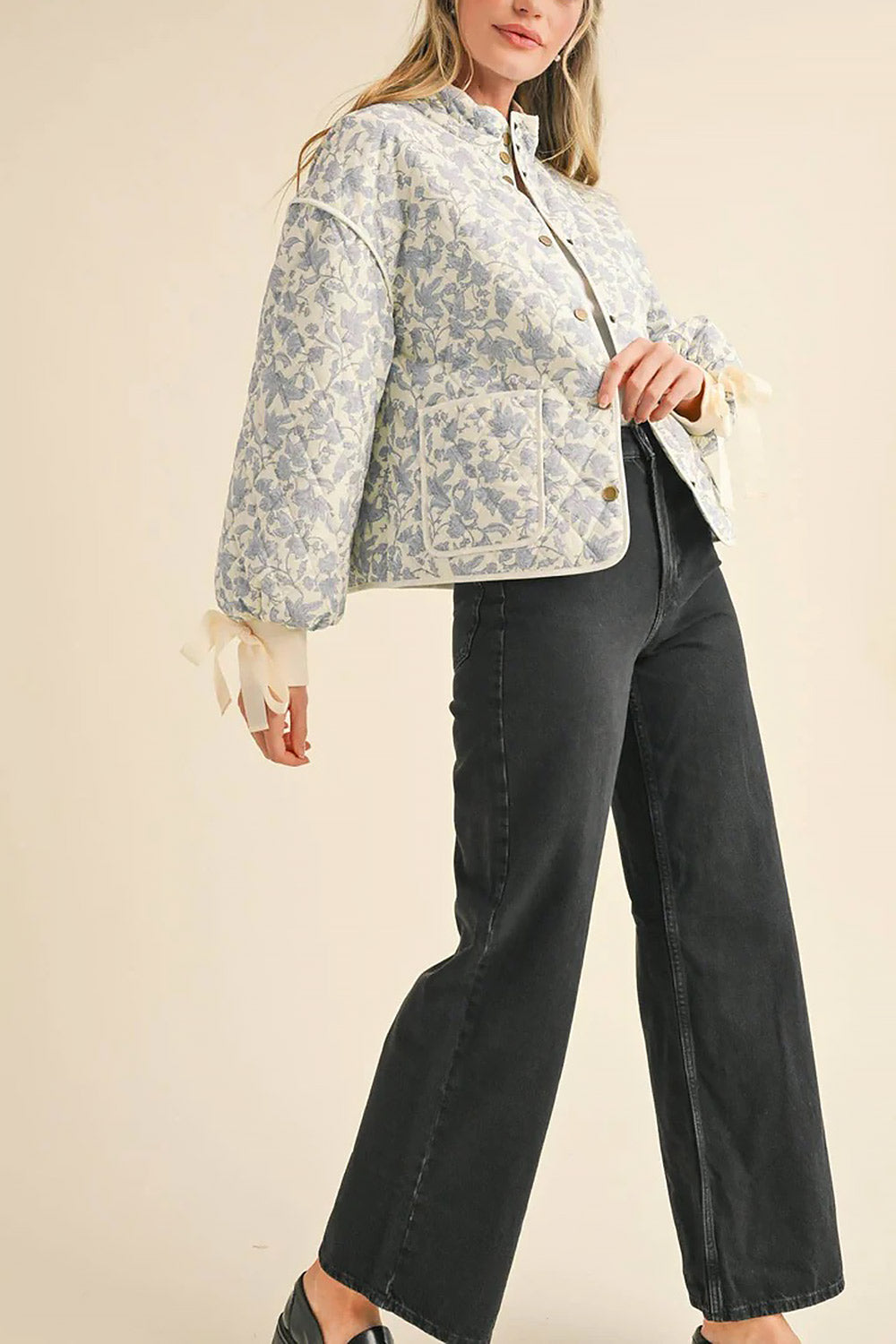 side of a woman wearing Anabeth Blue Floral Quilted Jacket with Ribbon-Tied from Boutique 1861
