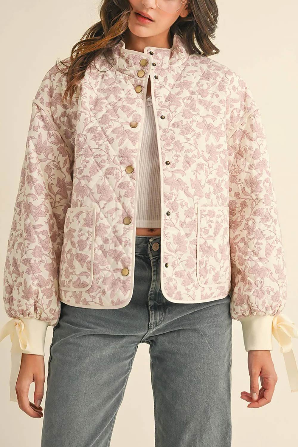 front of a woman wearing Anabeth Pink Floral Quilted Jacket with Ribbon-Tied from Boutique 1861
