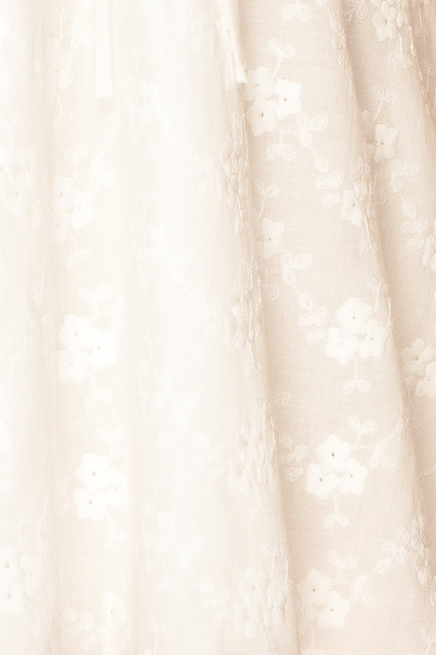 Close-up view Anysa White Floral Eyelet Mini Dress with Front Tie at boutique 1861