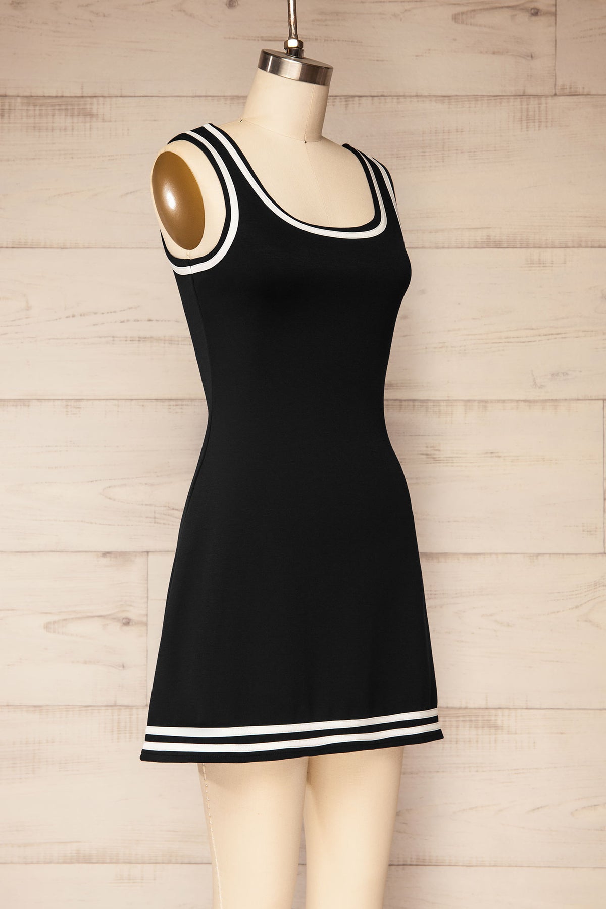 side view of Batala Black Contrast Trim Mini Dress with Built-In Shorts at La petite garçonne