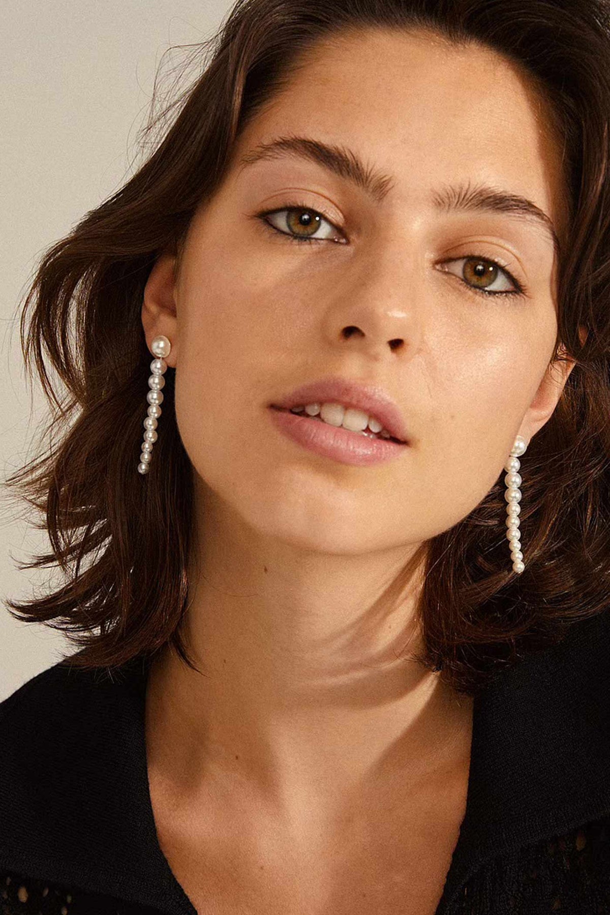 full face of a woman wearing Bellia Pearl Drop Earrings by Pilgrim from La petite garçonne