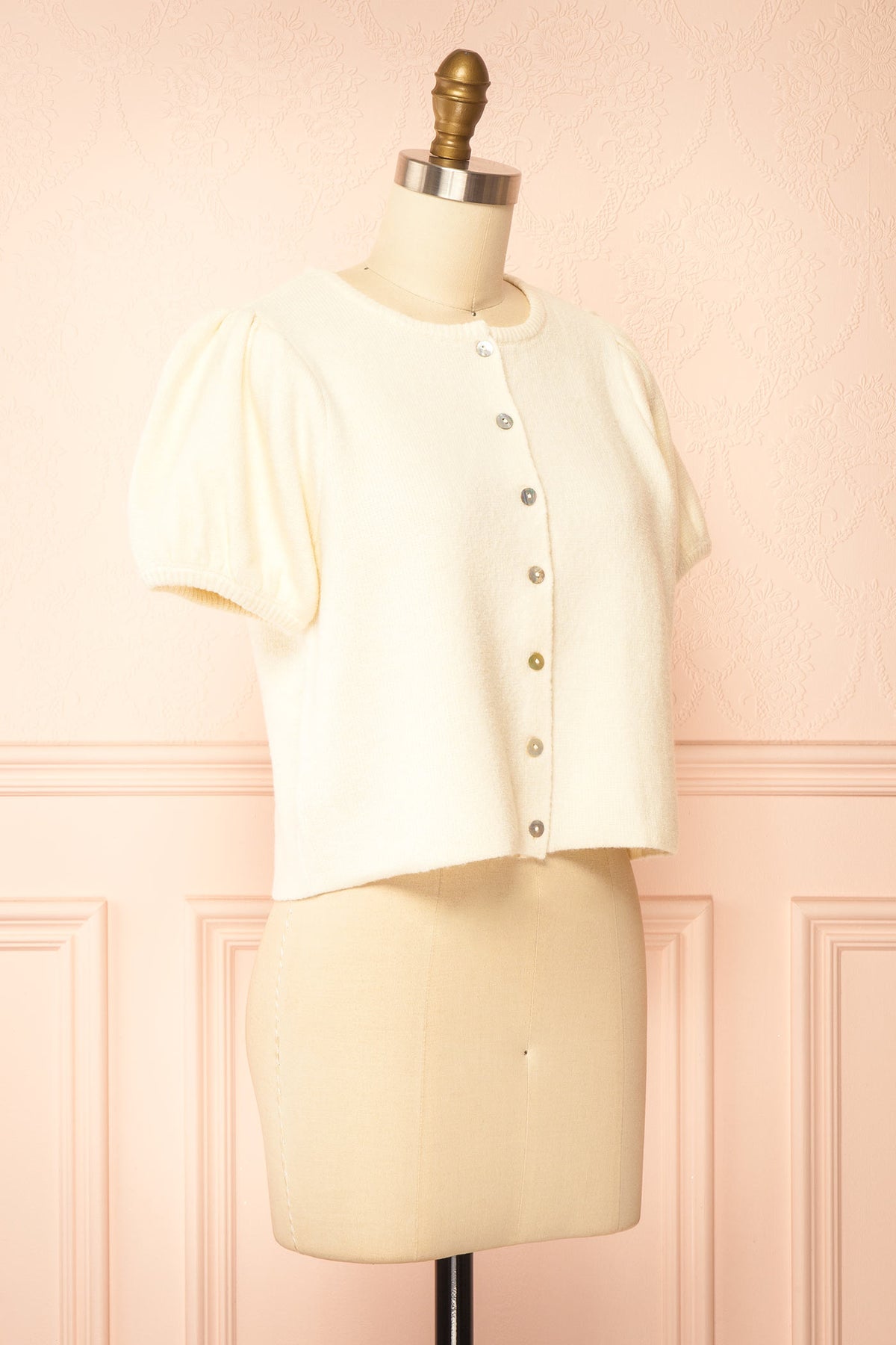 side view of Belza Ivory Short Sleeve Puff Sleeve Cropped Knit Cardigan at Boutique 1861