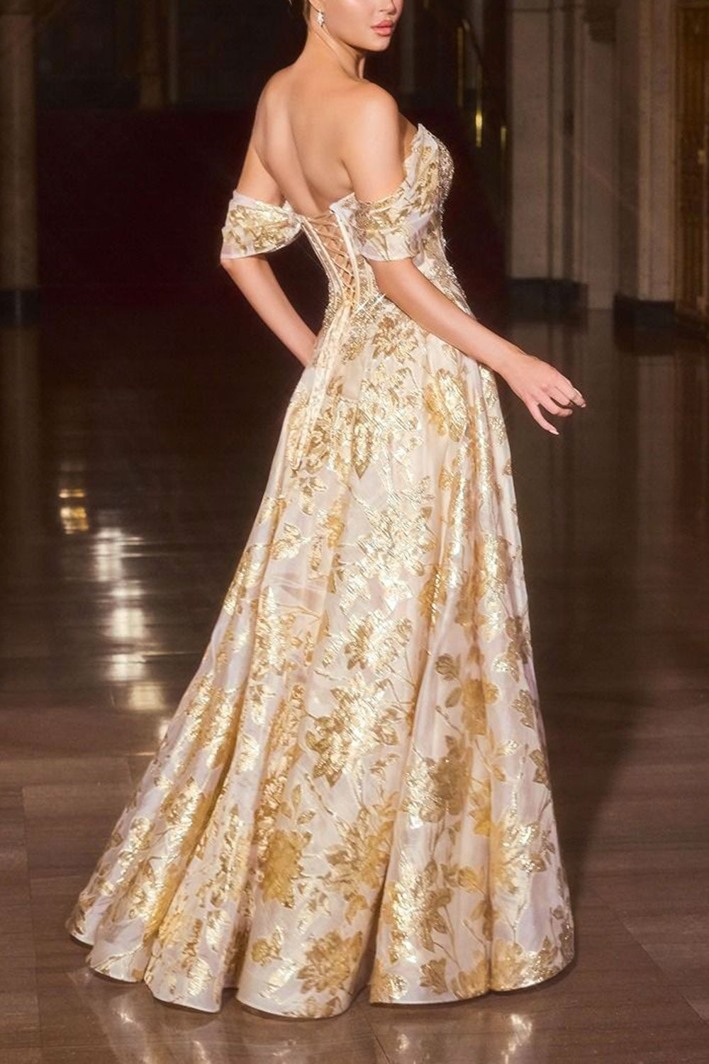 side view of a woman wearing Bridgitte Gold Off-Shoulder A-Line Maxi Corset Dress from Boutique 1861