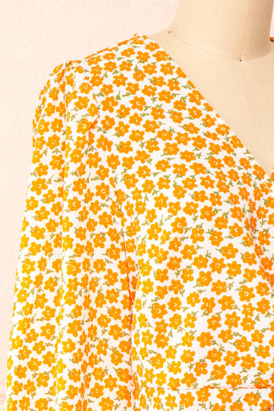 Calantra Faux Wrap Blouse w/ Orange Floral Motif | Boutique 1861  side close-up