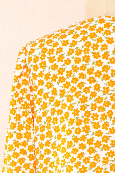 Calantra Faux Wrap Blouse w/ Orange Floral Motif | Boutique 1861  back close-up