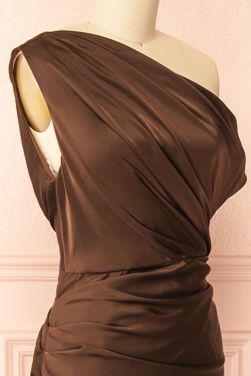  side front view of mannequin wearing Colleen Brown Asymmetrical Satin Dress from boutique 1861