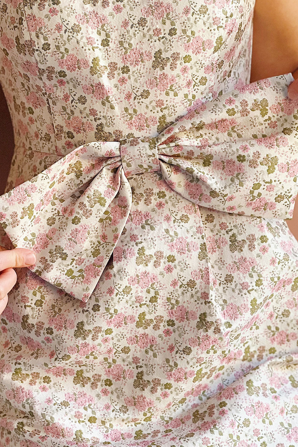 Woman wearing Maram Long Floral Dress with a close up on the Bow 