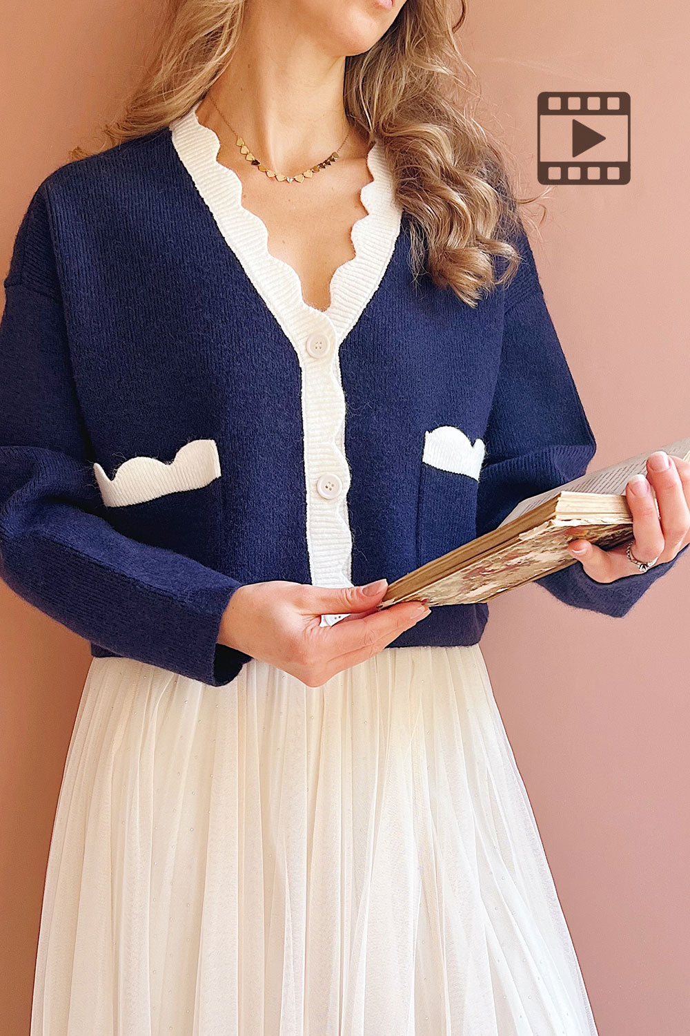 Model wearing the navy cardigan with white trim Sayda from 1861