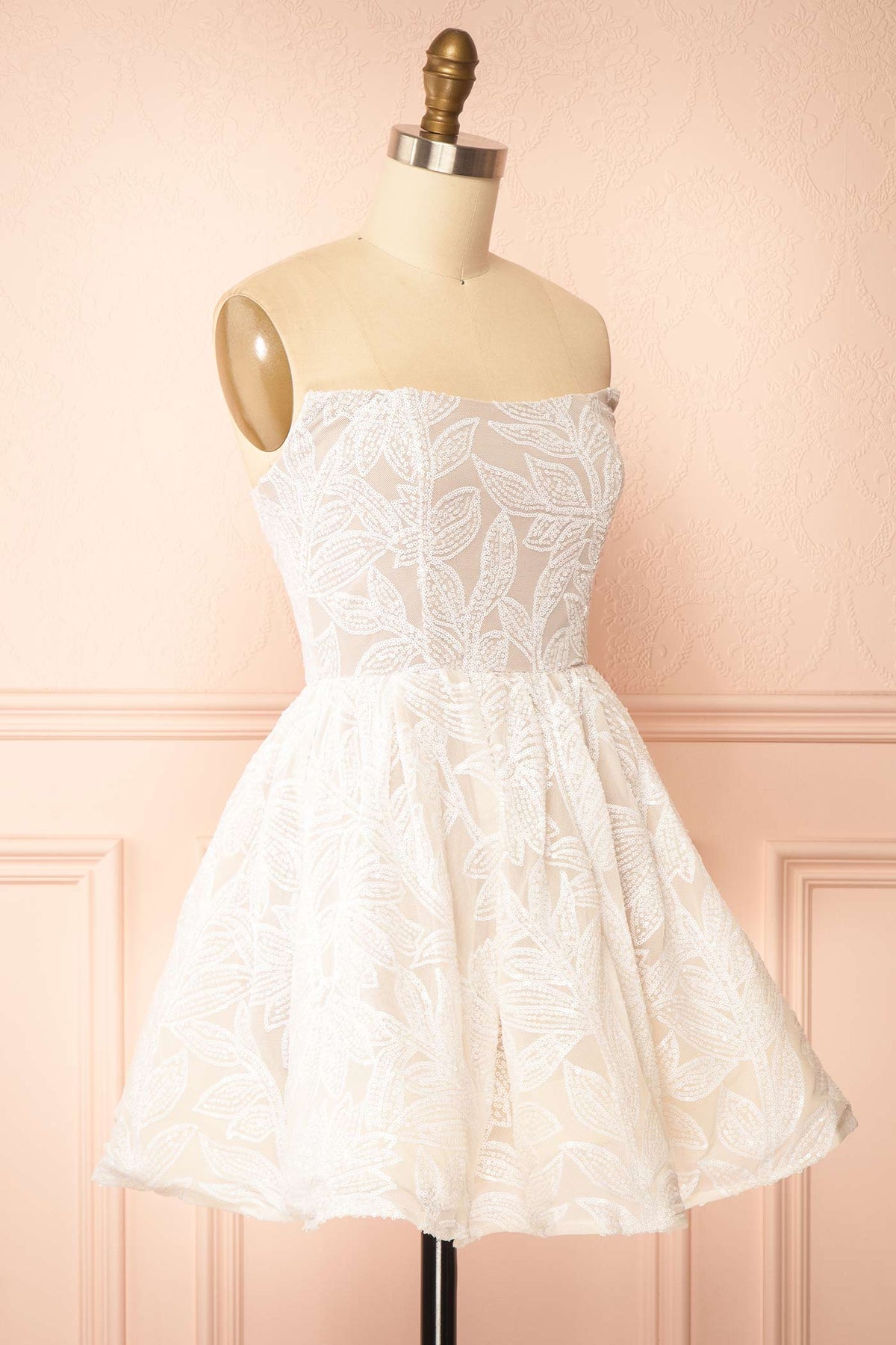 Side view of Daina White Strapless Sequin Embroidered Mini Dress at Boutique 1861 