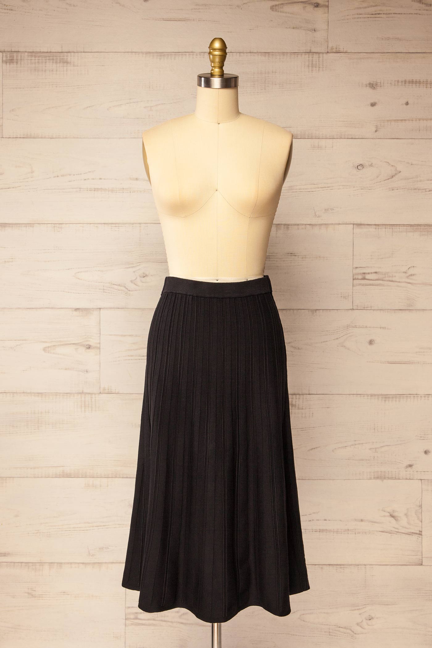 front view of Devonport Black High-Waisted Ribbed Knit Midi Skirt at La petite garçonne