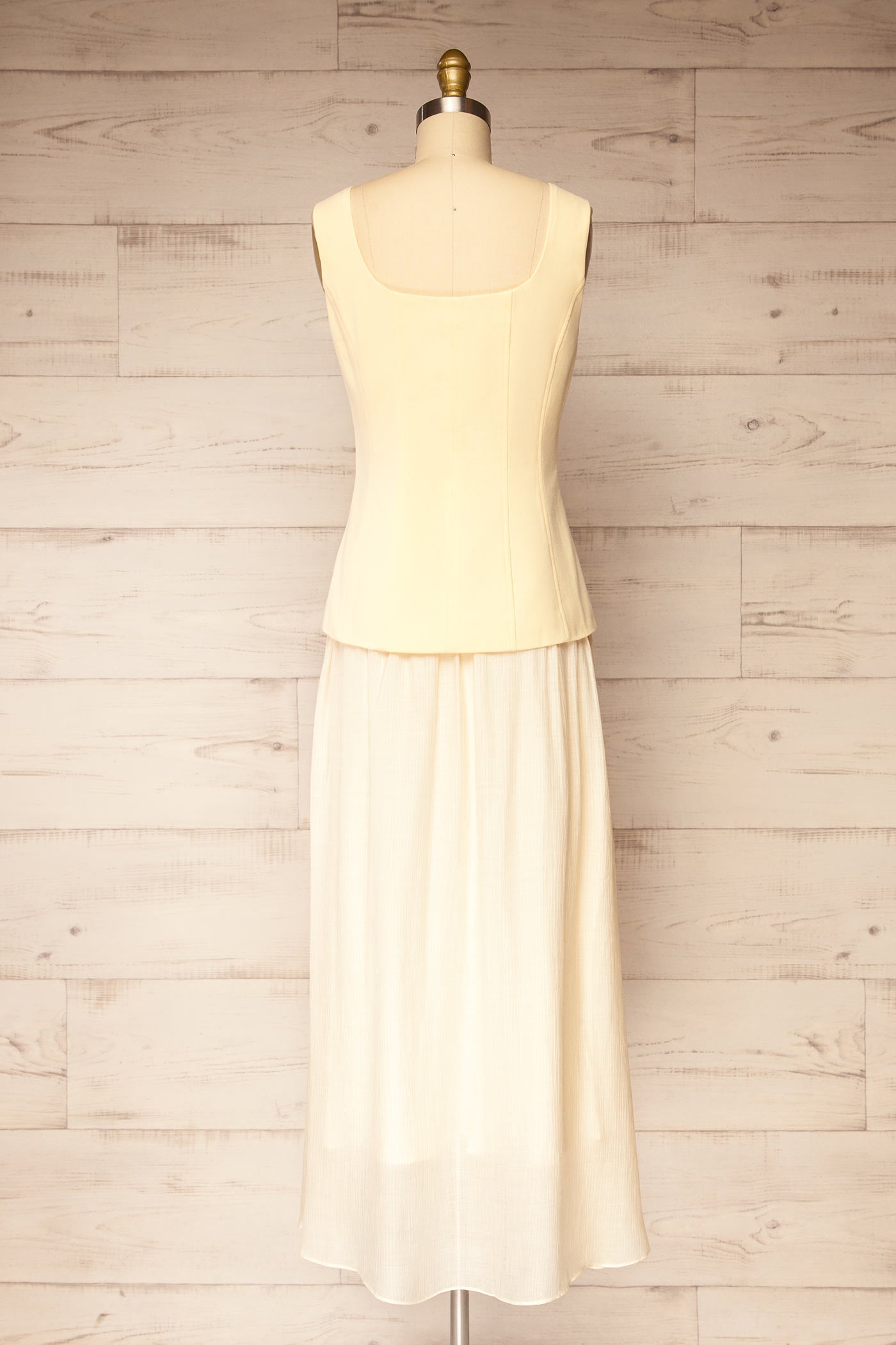 Back view Dhule Light Yellow Sleeveless Contrast Maxi Dress with Button at la petite garçonne