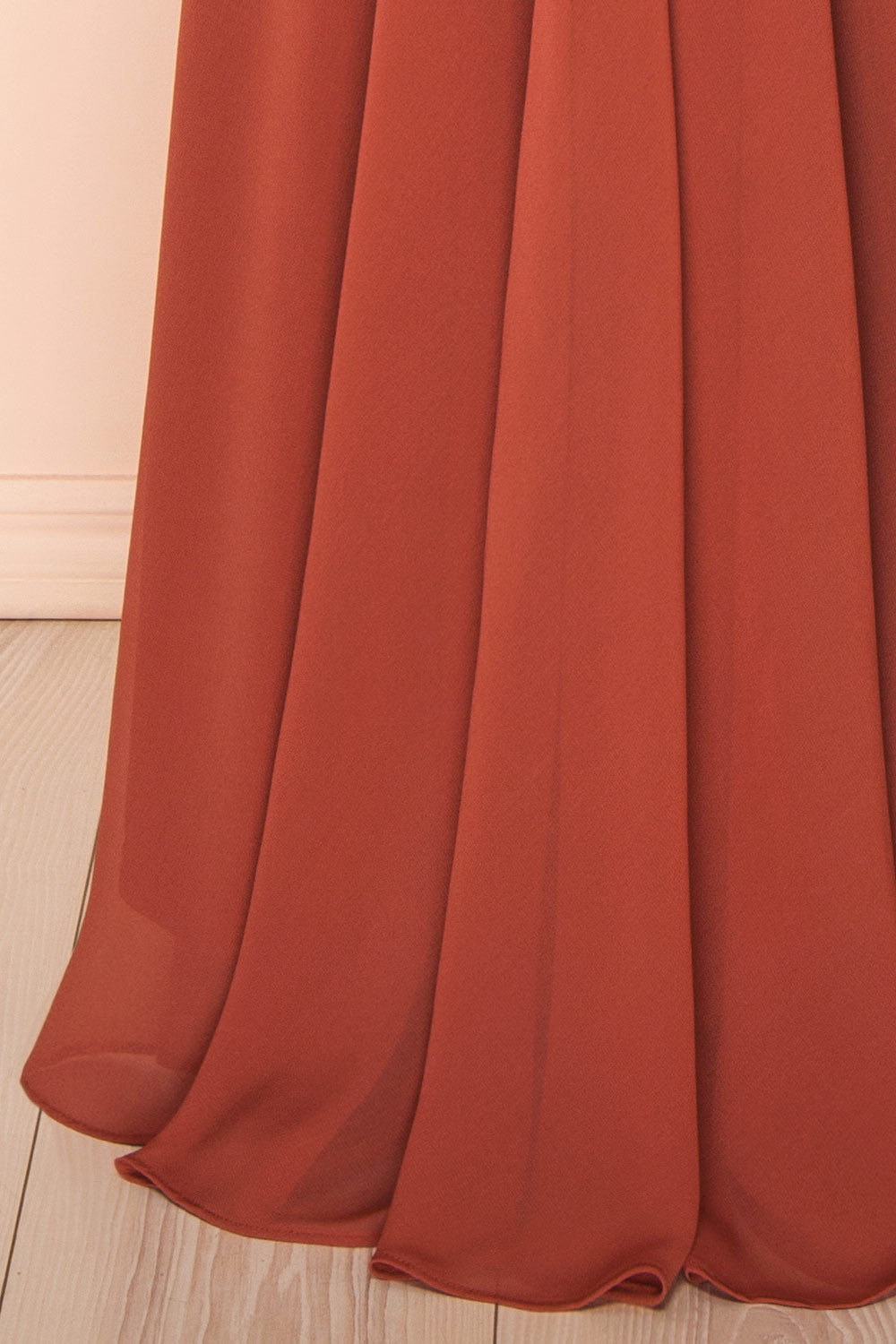 bottom of a mannequin wearing Diana Rust Exclusive 1861 A-Line Chiffon Dress with Slit | Boutique 1861