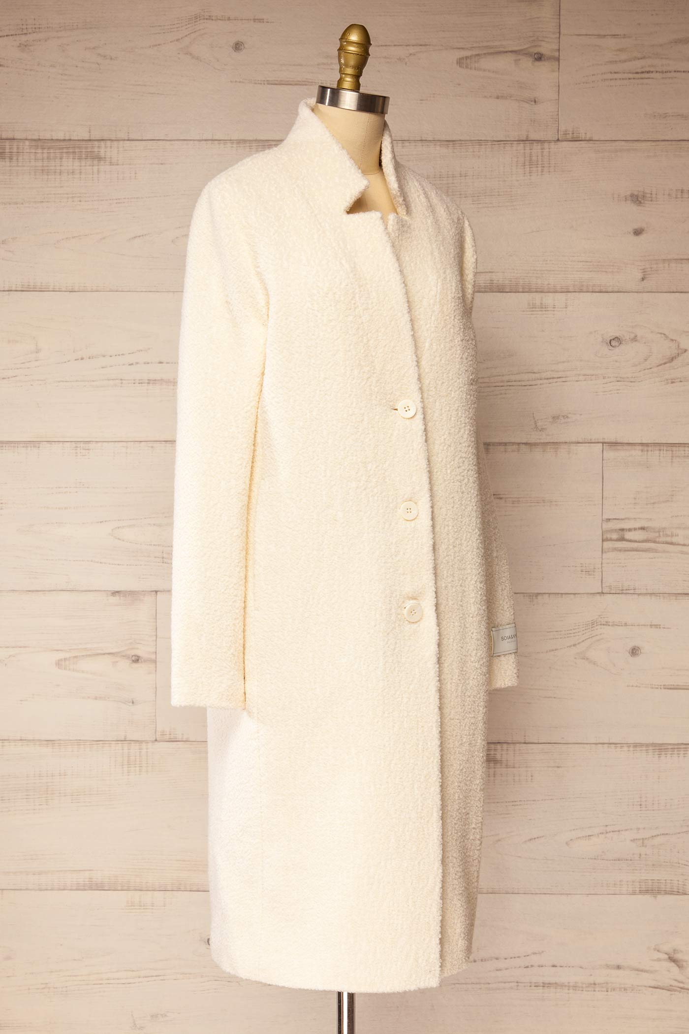 side view of Diane Ivory Curly Wool Coat with Pockets at La petite garçonne