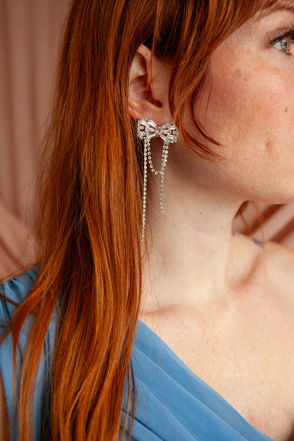woman wearing Dolaricia Silver Bow Earrings with Pendant Chains | Boutique 1861