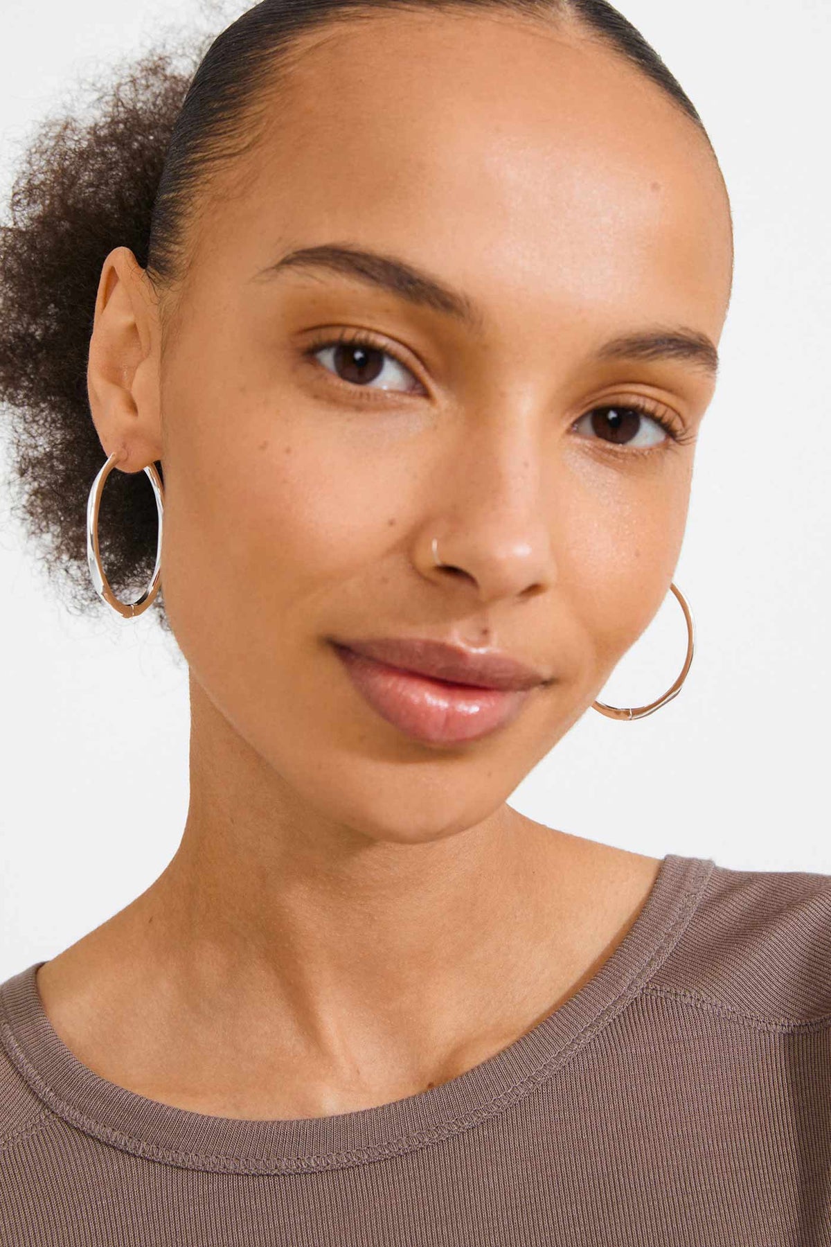 view of a woman wearing Edelia Silver Wave Hoop Earrings by Pilgrim from La petite garçonne