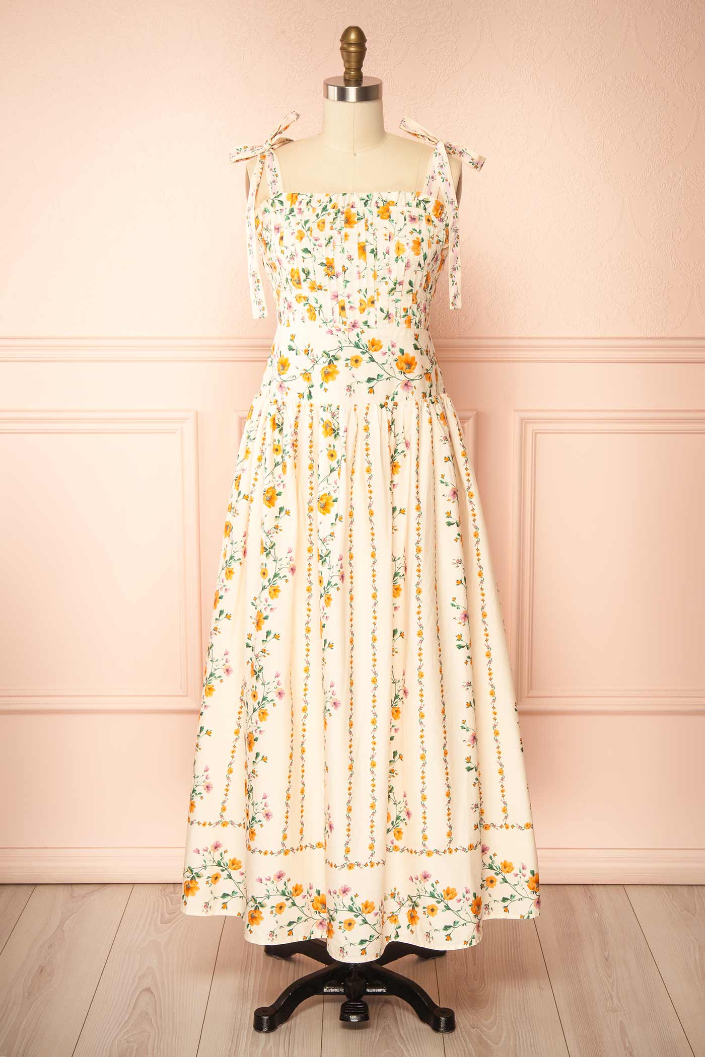 Front view Emberlyn Beige Floral Tie-Strap Smocked Midi Dress with Pleated Skirt at boutique 1861