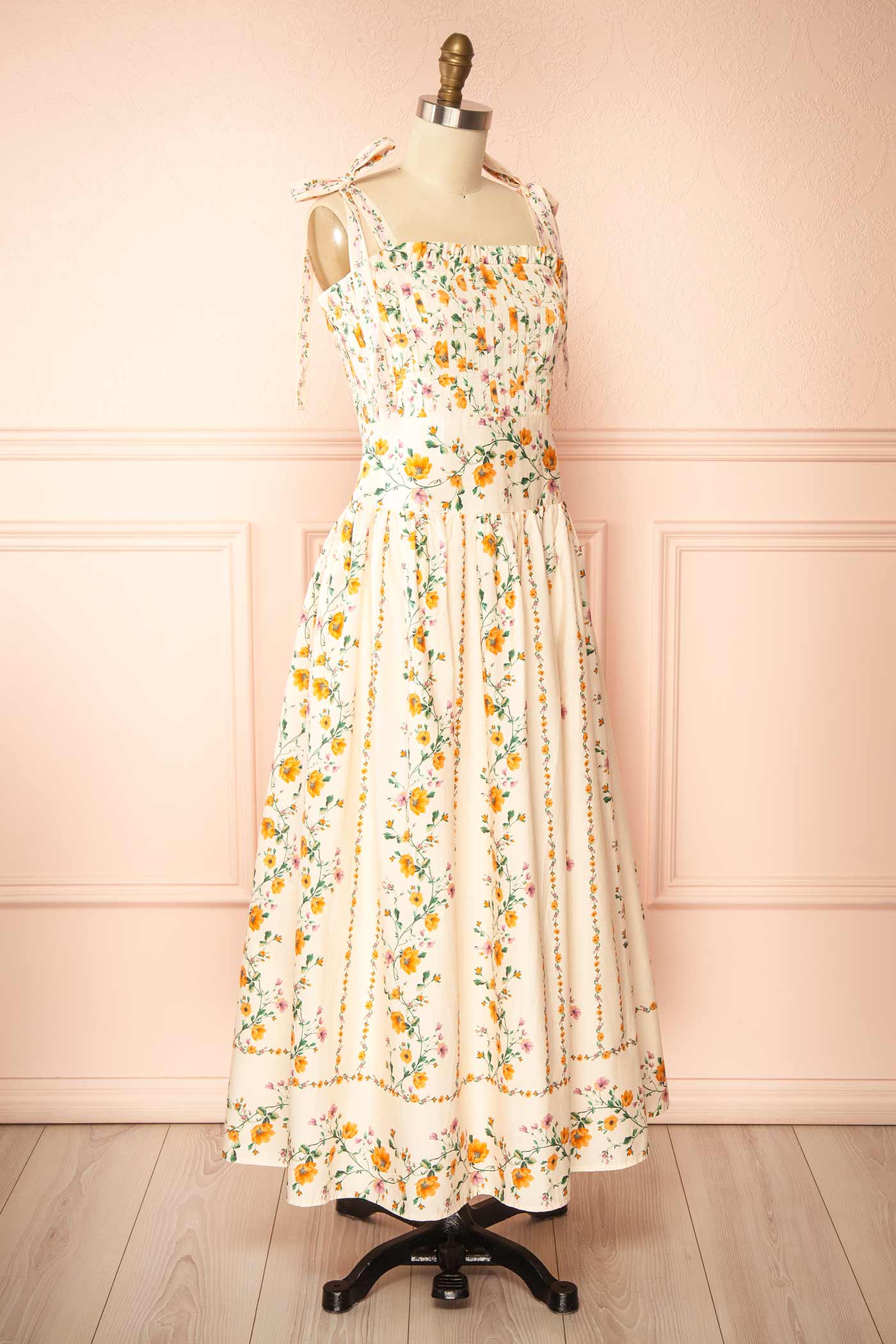 Profile view Emberlyn Beige Floral Tie-Strap Smocked Midi Dress with Pleated Skirt at boutique 1861