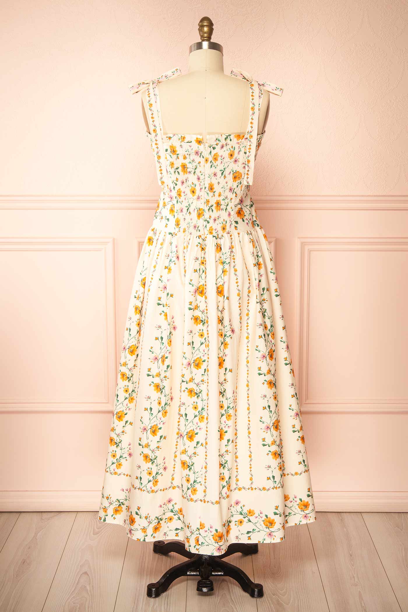 Back view Emberlyn Beige Floral Tie-Strap Smocked Midi Dress with Pleated Skirt at boutique 1861