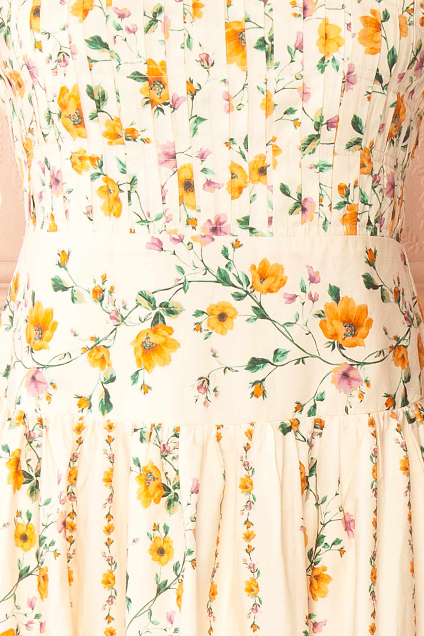 Close-up view Emberlyn Beige Floral Tie-Strap Smocked Midi Dress with Pleated Skirt at boutique 1861