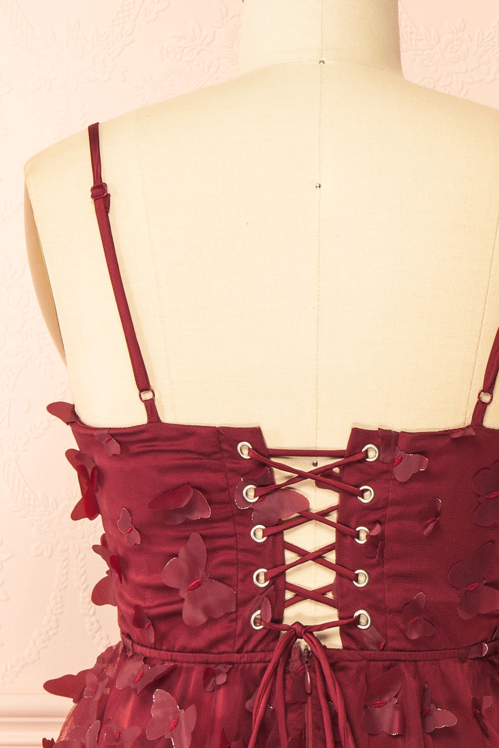 back of a sewing mannequin wearing Faya Burgundy Short Corset Dress with Butterflies from Boutique 1861
