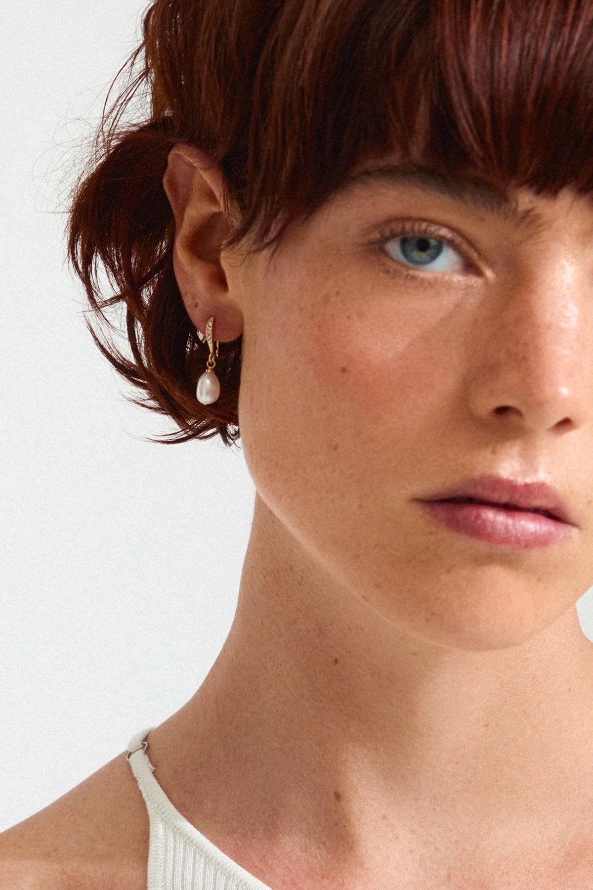 a woman wearing Florea Gold Pearl Drop Earrings with Crystals by Pilgrim from La petite garçonne