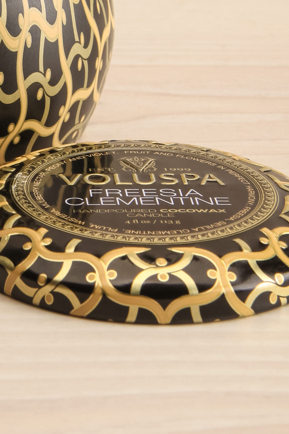 Freesia Clementine Mini Tin Candle by Voluspa | Maison garçonne lid close-up