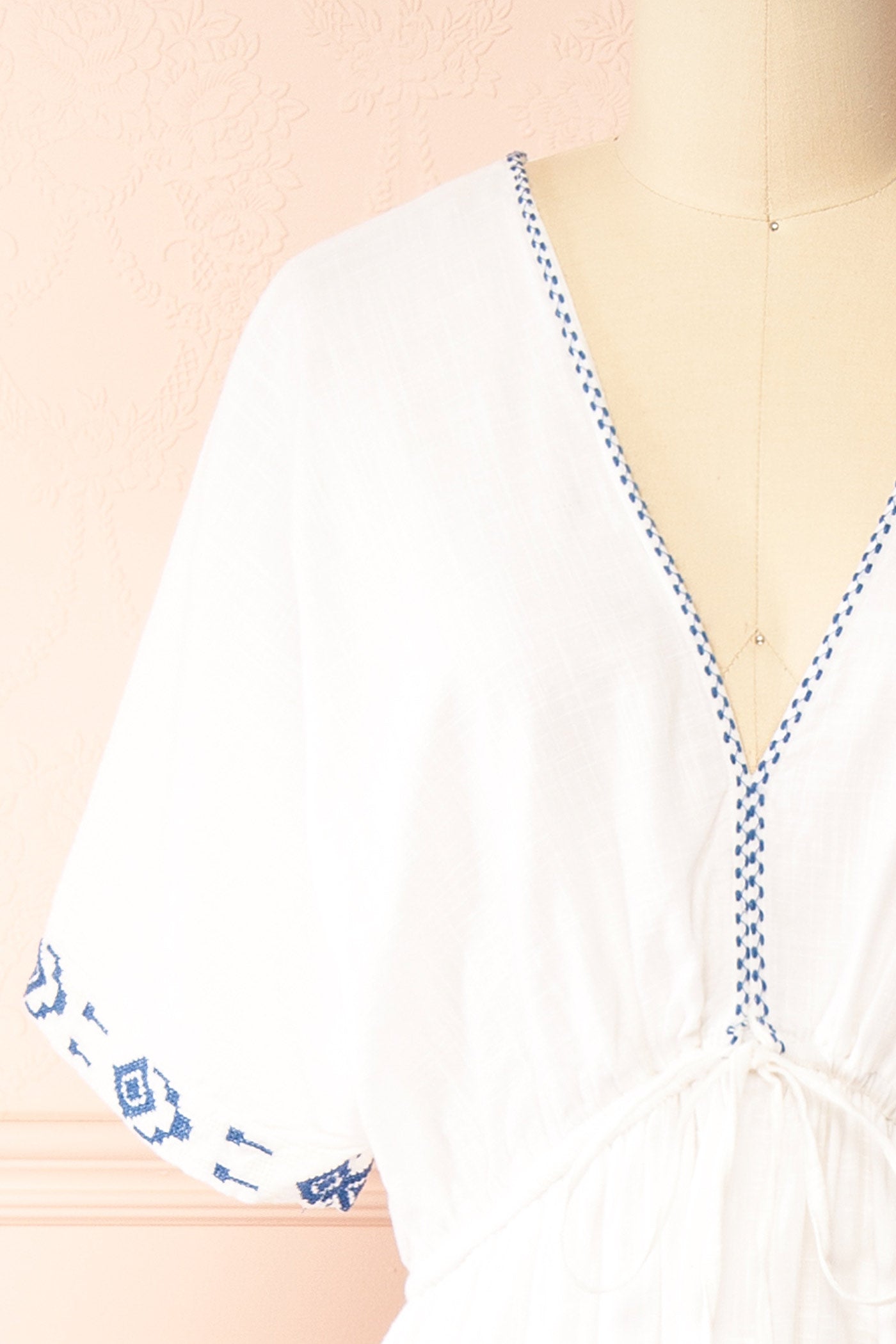 Close-up Georgette Embroidered White V-Neck Maxi Dress with Tassel Tie at boutique 1861