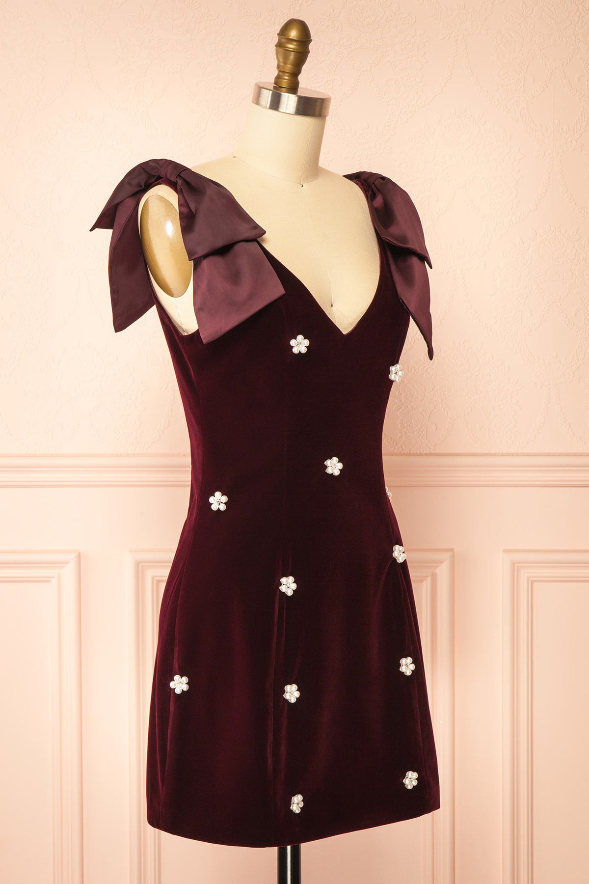 Side view of Geynneth Burgundy Velvet Pearl Embellished Bow Shoulder Mini Dress at Boutique 1861 