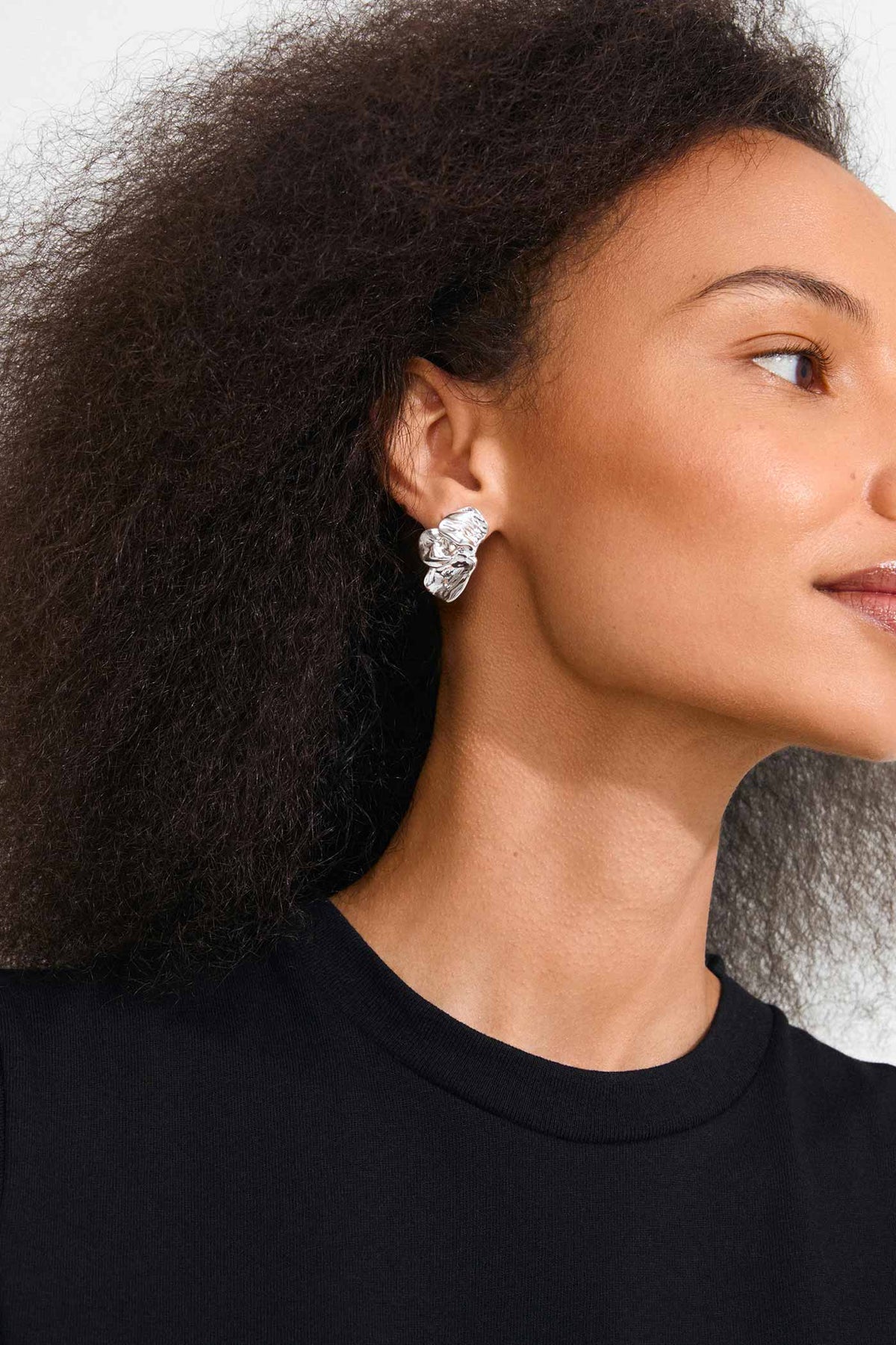 a woman wearing Halua Silver Large Petal Stud Earrings by Pilgrim from La petite garçonne