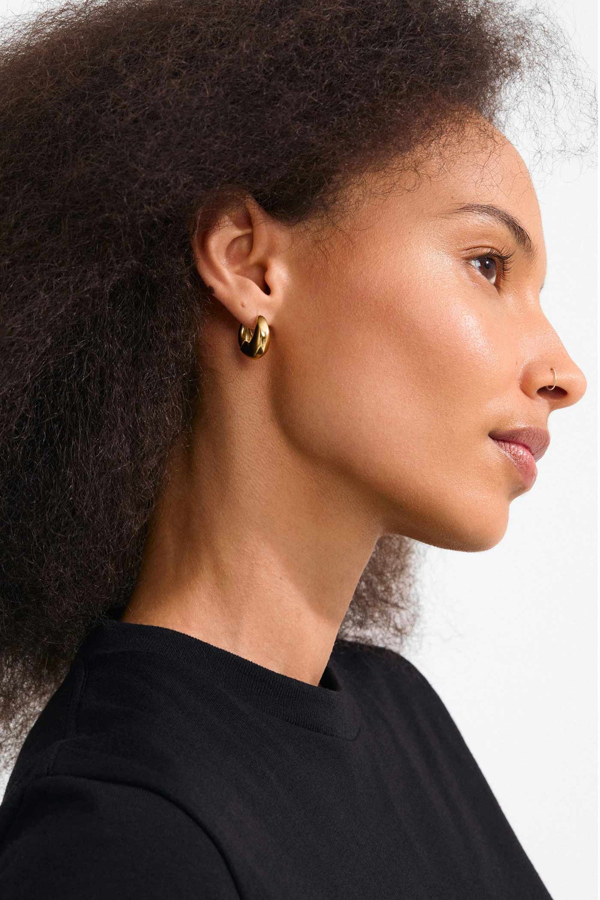 side view of a woman wearing Ignis Gold Small Chunky Hoop Earrings by Pilgrim from La petite garçonne