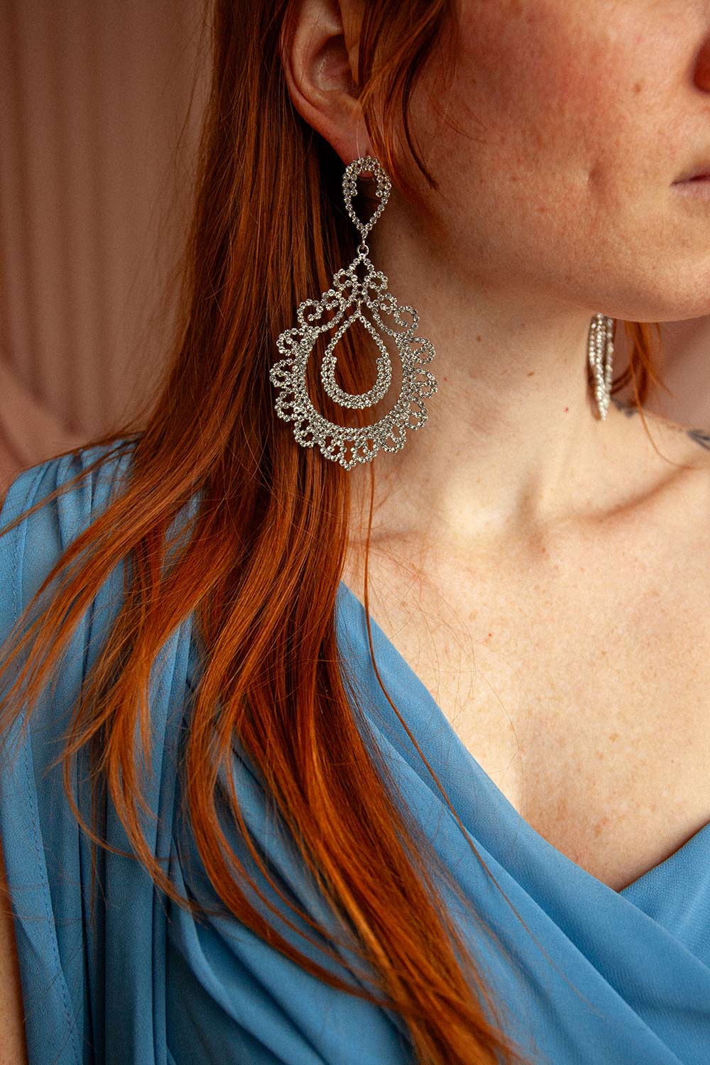 woman wearing Nehla Silver Pendant Crystal Earrings from Boutique 1861