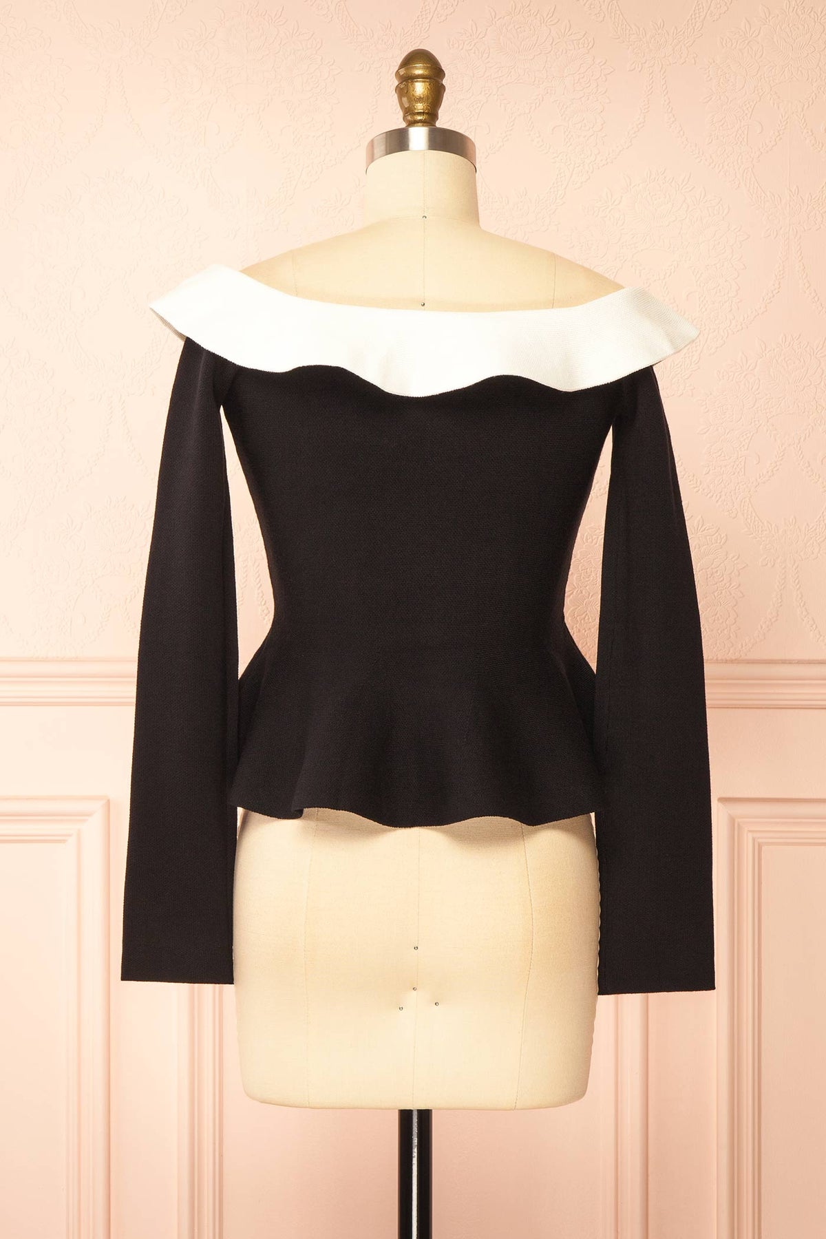 back view of Nuuk Black Off-the-Shoulder Peplum Top at Boutique 1861