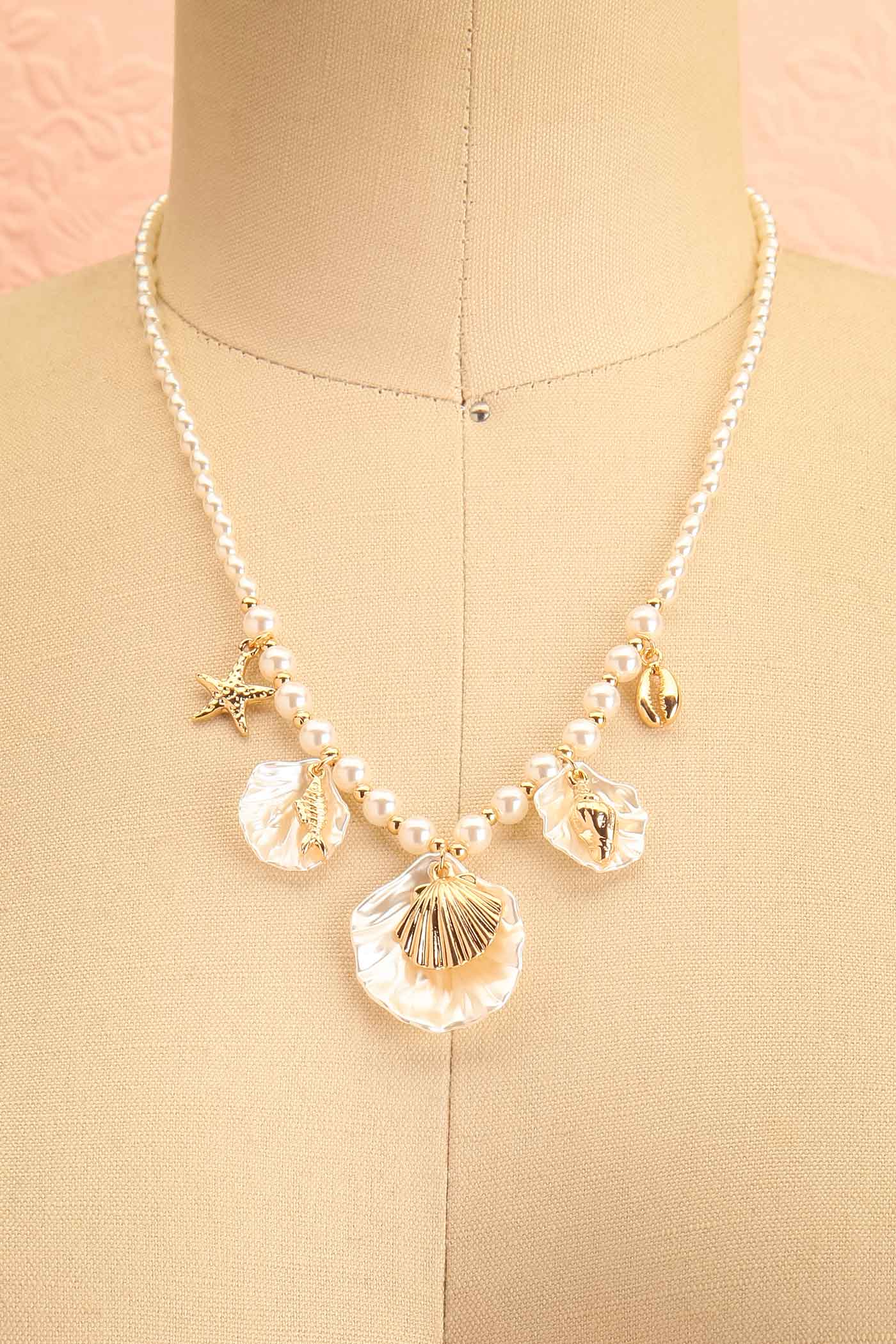 Nyxar Gold Seashell Charm Pearl Necklace on a mannequin