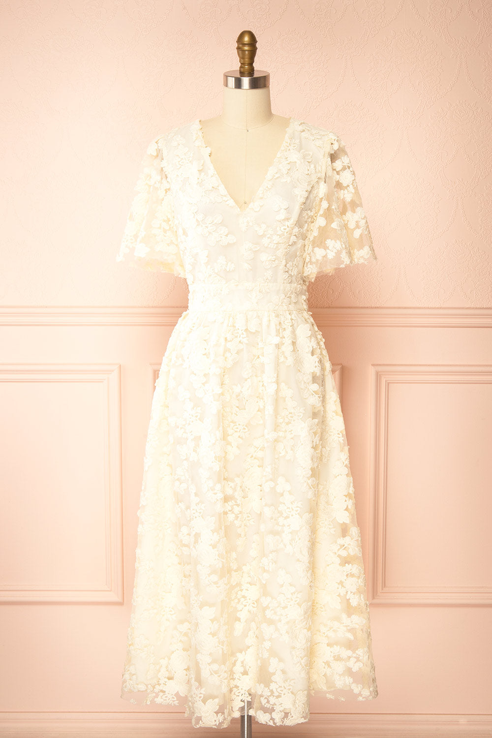 front view  of a Mannequin wearing the Oukie Ivory Midi Floral Lace Dress from boutique 1861