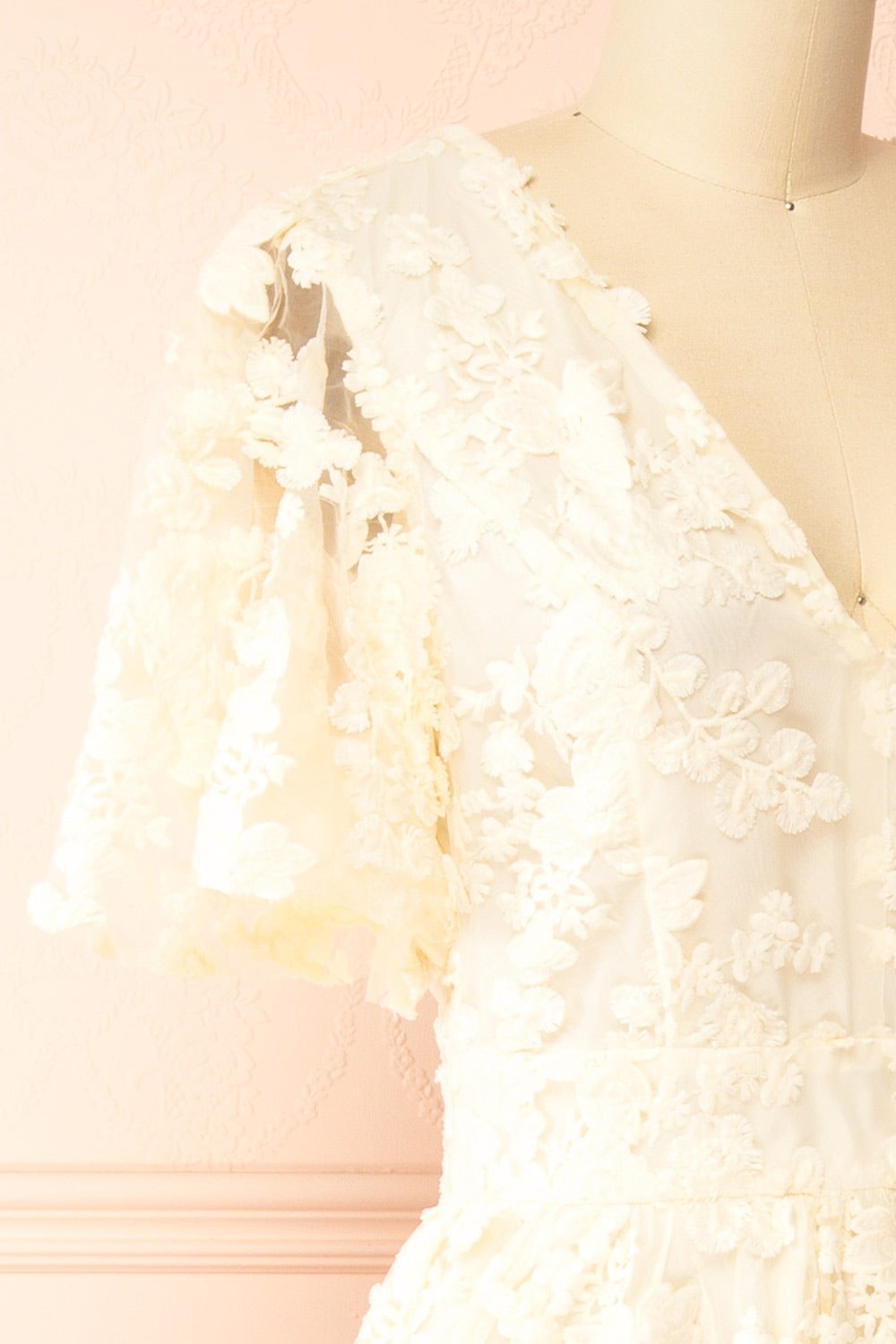 side  of a Mannequin wearing the Oukie Ivory Midi Floral Lace Dress from boutique 1861