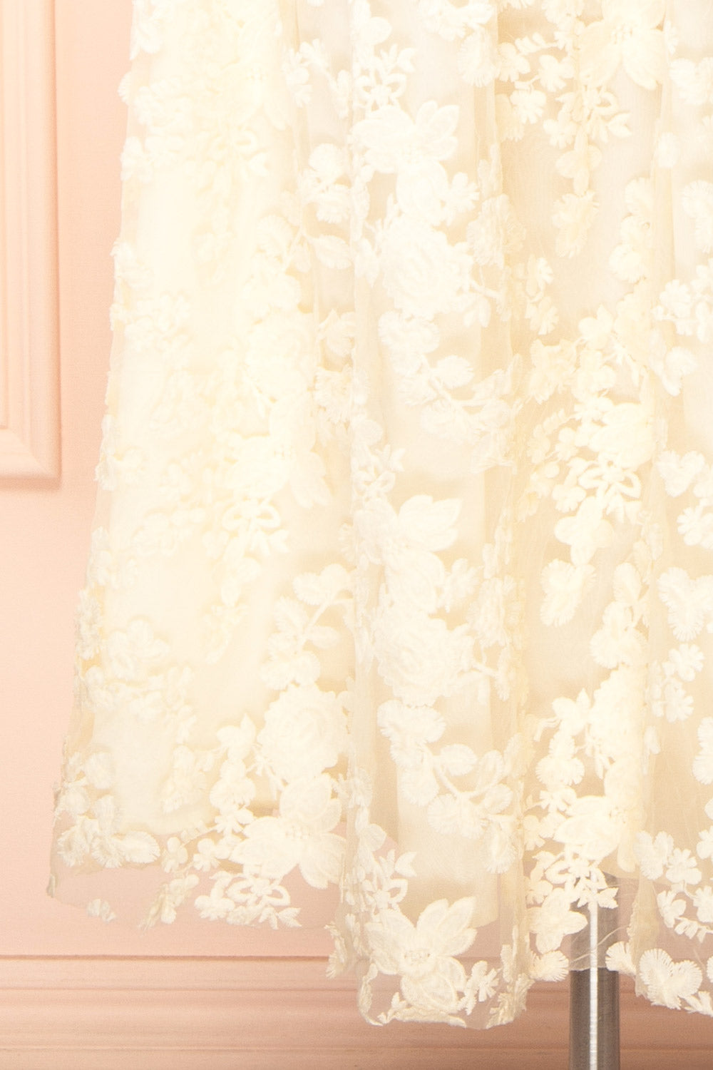 bottom  of a Mannequin wearing the Oukie Ivory Midi Floral Lace Dress from boutique 1861