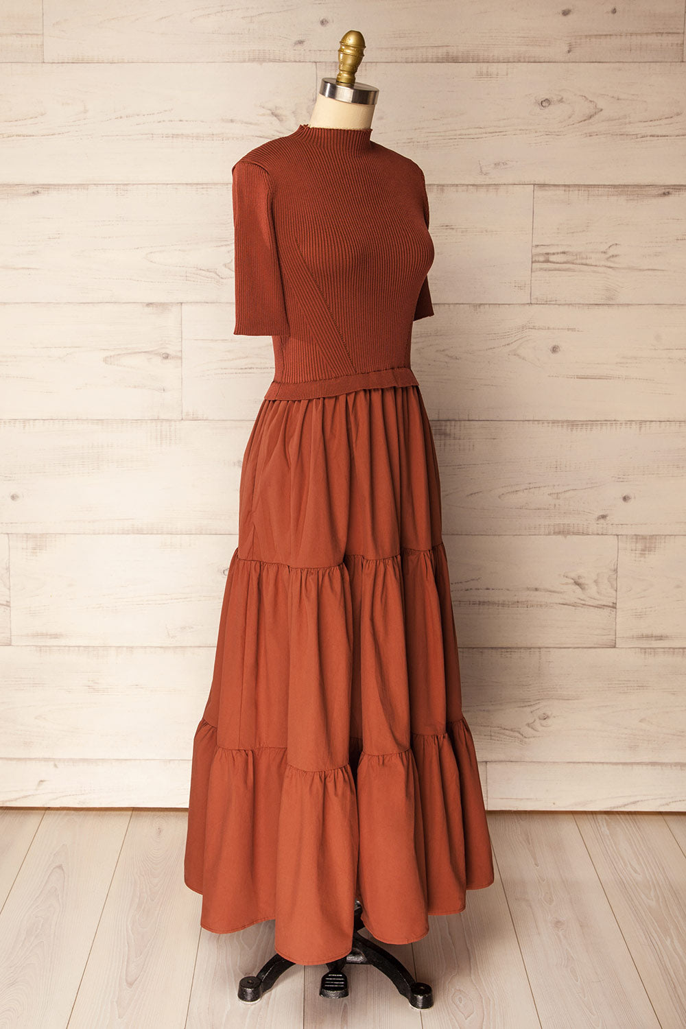side view of a mannequin wearing the Penrith Rust Mock Neck Midi Dress from boutique 1861