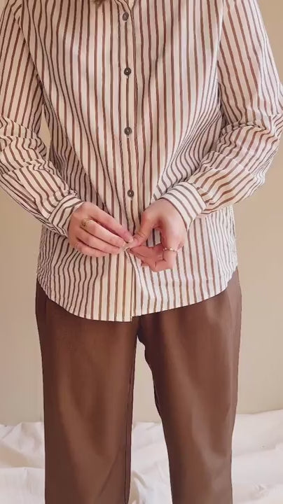 Video Model wearing the brown and white striped shirt Safire with brown pants