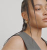 Video of a woman wearing a gold hoop earring Besi from Pilgrim available at la petie garçonne in Montreal.
