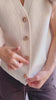 Video of a model wearing Castelo Ivory Sleeveless Knit Vest from La petite garçonne 
