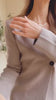 Woman wearing Louxor Taupe Knitted Flared Cardigan from La petite garçonne video
