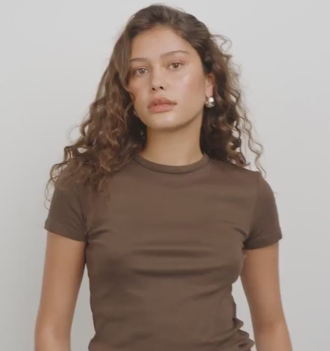 Video of a woman wearing a silver hoop earring Besi from Pilgrim available at la petie garçonne in Montreal.