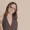 Video of a Woman wearing brown sunglasses by Pilgrim available at la petite garçonne