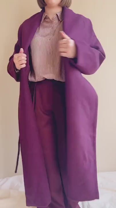Video of a Model wearing Padua, a long Burgundy coat with a belt