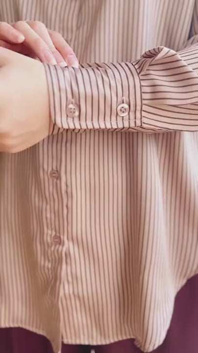 Video of a Model wearing the striped shirt Hazro against a beige background