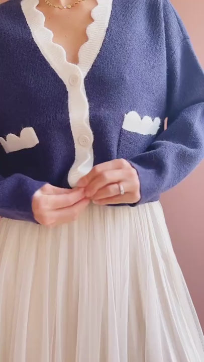 video of a Model wearing the navy cardigan with white trim Sayda from 1861